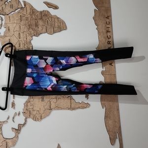 Black leggings with blue, pink geometric pattern and mesh bottoms.